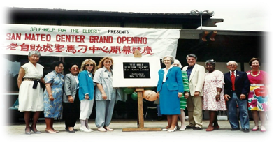 San Mateo Self Help for the Elderly center opening with visitors in front of a sign